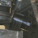 The black cylinder with writing on it is an oil filter.