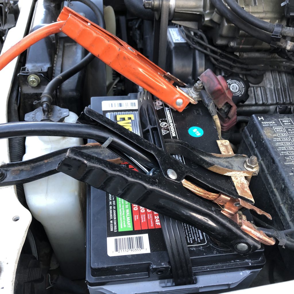 Jumper cables on good battery for jump start safety